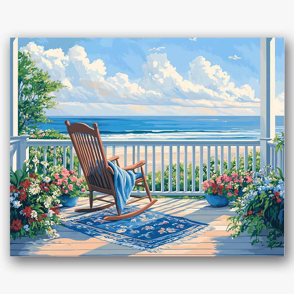Paint by numbers design of rocking chair, flowers, blue ocean waves, fluffy white clouds