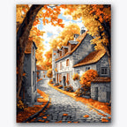 Paint by numbers design of cobblestone street, autumn trees, cobblestone path, rustic buildings
